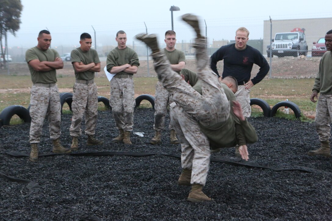 Lance Cpl. Bryan Polonia, class participant and a Stamford, Conn., native executes a hip throw on Lance Cpl. Zachary Acevedo, class participant and a Chicago native during Marine Corps Martial Arts Program training aboard Marine Corps Air Station Miramar, Calif., March 26. Morning instructional sessions serve as both an educational platform and an escape from the daily grind for Marines of Marine Tactical Air Command Squadron 38.
