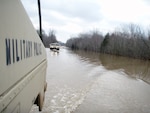 Members of the Missouri National Guard's 70th Troop Command ford a crossing near Piedmont, Mo., on March 19, 2008, while providing support to civilian authorities in the wake of Midwest storms that caused flooding in multiple states. President Bush declared a major disaster for the state.