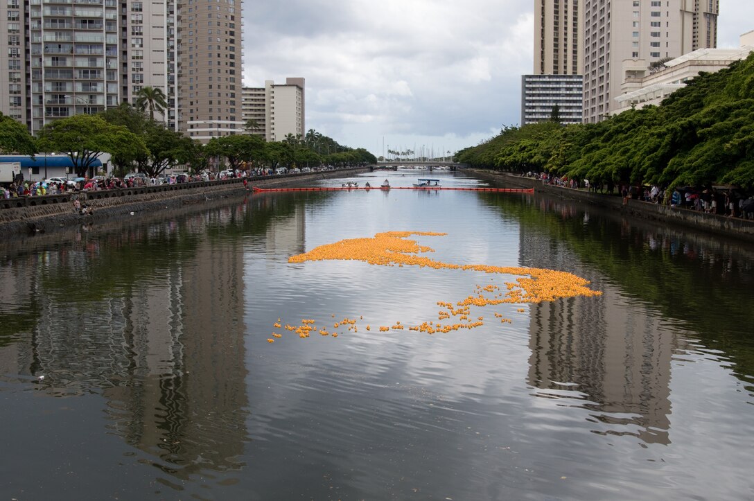 HONOLULU - A crowd watches as 20,000 rubber duckies float down the Ala Wai Canal toward the finish line during the 26th annual Hawaiian Rubber Duckie Race, March 30, 2013. The race is a fundraiser for the Cerebral Palsy Association of Hawaii. Participants pay a small fee to "adopt" a duck, and the first 50 finishers and the last duck receive prizes. (U.S. Marine Corps photo by Kristen Wong)