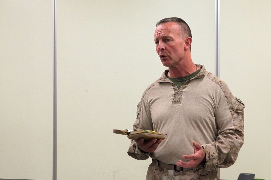Commander Michael Williams, the Regimental Combat Team 7 chaplain, preaches during a protestant Easter service here, March 30. Williams and Capt. Francis Foley, the 3rd Marine Aircraft Wing chaplain, are on a two-week tour of the area of operations providing Easter services and counseling.