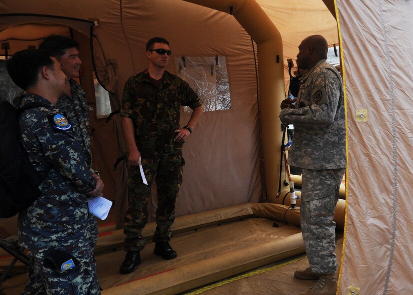 KAPOLEI, Hawaii -- Sgt. 1st Class James Sturdivant, 71st Army/93d Civil Support Team training and decontamination NCO, talks about a decontamination system to civil engineers from several Asia-Pacific nations as they participated in a Subject Matter Expert exchange as part of Pacific Unity/Defender April 4, 2013. Members of the Republic of Singapore Air Force, Japan Air Self-Defense Forces, Royal Thai Air Force, Royal New Zealand Army and Royal Cambodian Air Force participated in the exchange, part of U.S. Pacific Command’s Theater Security Cooperation Program, co-hosted by senior civil engineering and security forces personnel from PACAF. (U.S. Air Force photo/Tech. Sgt. LuCelia Ball)
