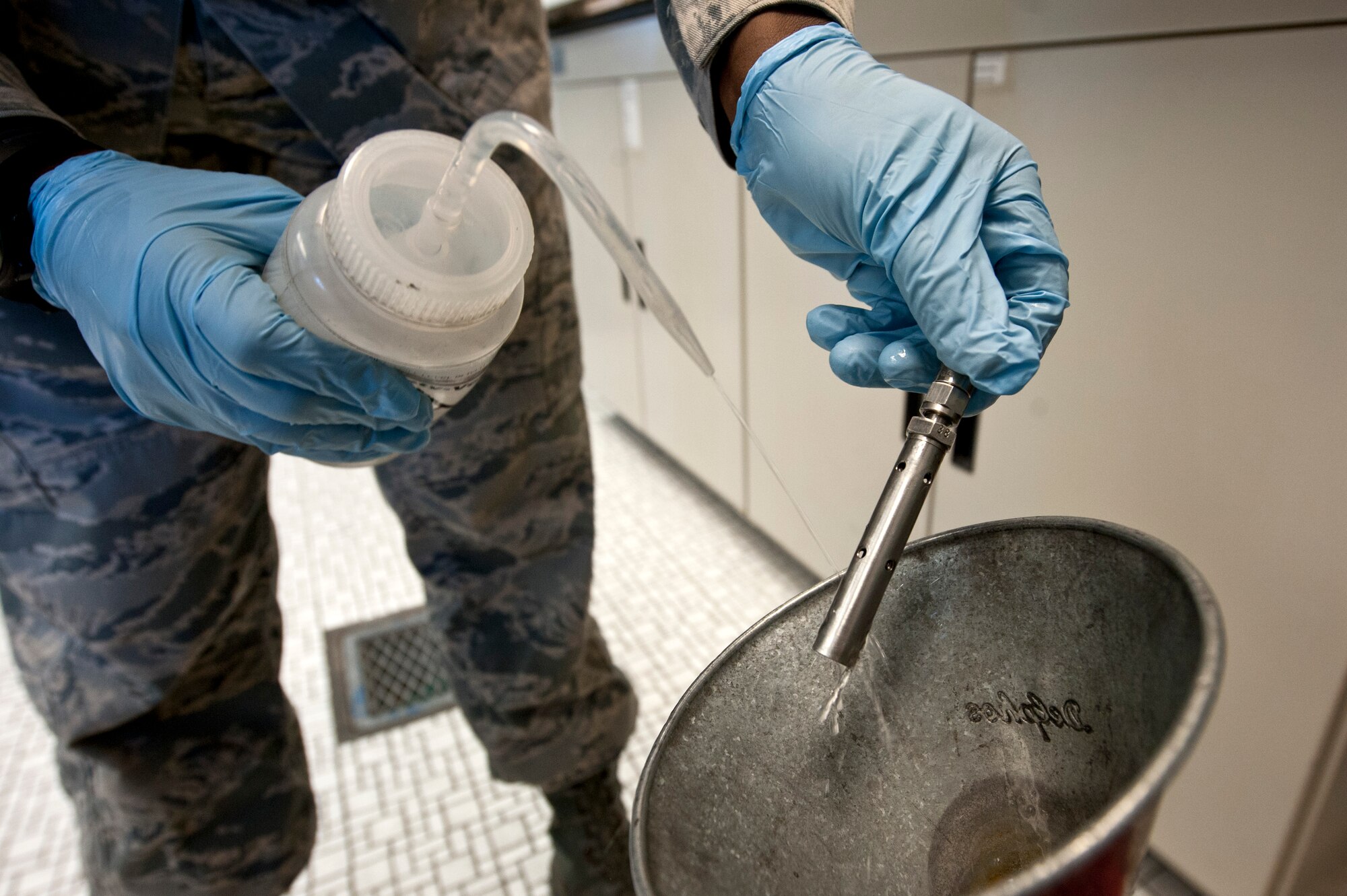 Senior Airman Courtney Lewis, 99th Logistics Readiness Squadron fuels laboratory technician, cleans a conductivity probe Feb. 28, 2013, at Nellis Air Force Base, Nev. Fuel is sampled and tested daily for particulates. The conductivity probe is cleaned to ensure the next batch of fuel isn’t contaminated when using the same probe. Jet fuel conductivity determines the degree at which jet fuel transmits an electric charge and indirectly the degree at which it could potentially spark and ignite. (U.S. Air Force photo by Airman 1st Class Jason Couillard)