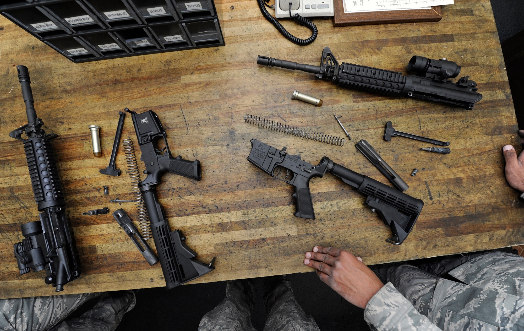 After firing each shooter is required to break down their rifle and thoroughly clean it in the Combat Arms Training and Maintenance classroom at Fairchild Air Force Base, Wash., March 25, 2013. Each year the CATM instructors are required to inspect every weapon on the base. (U.S. Air Force photo by Airman 1st Class Ryan Zeski)