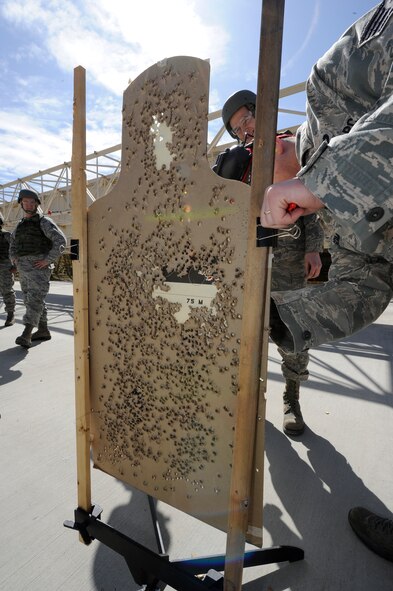 Staff Sgt. Austinlane Montgomery, 92nd Security Forces Squadron combat arms instructor, checks the target for shots within the target area at the Combat Arms Training and Maintenance range at Fairchild Air Force Base, Wash., March, 25, 2013. Shooters who hit 22 out of 24 targets earn the marksman ribbon. (U.S. Air Force photo by Airman 1st Class Ryan Zeski)