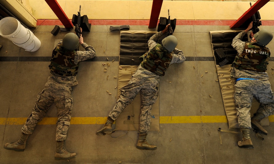 Shooters fire live rounds down the range as part of M4 training at the Combat Arms Training and Maintenance range at Fairchild Air Force Base, Wash., March 25, 2013. The instructors at CATM have classes to train Airmen year round. (U.S Air Force photo by Airman 1st Class Ryan Zeski)
