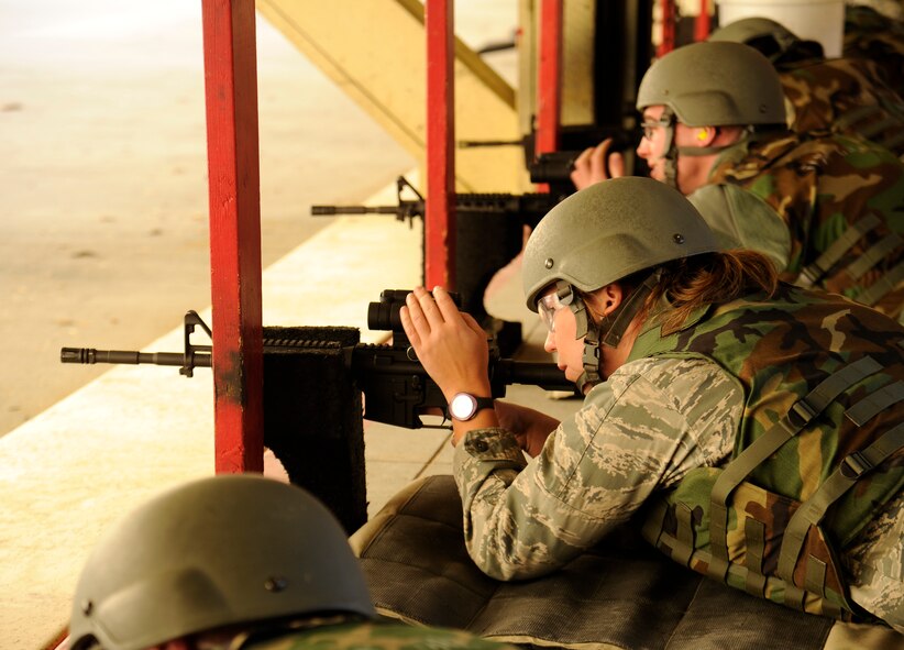 Capt. Lauren Robillard, 36th Rescue Flight pilot, aims down the sights of an M4 rifle at the shooting range at Fairchild Air Force Base, Wash., March 25, 2013. During the qualification shooters who hit 22 out of 24 targets earn the marksman ribbon. (U.S. Air Force photo by Airman 1st Class Ryan Zeski)