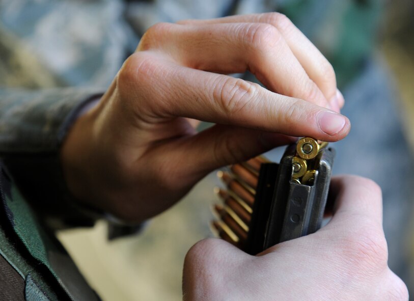 Airman 1st Class Sean Cummings, 92nd Logistics Readiness Squadron fuels distribution apprentice, manually loads rounds into the clip for a M4 rifle at the shooting range at Fairchild Air Force Base, Wash., March 25, 2013. More than 400,000 rounds are fired each year at the Combat Arms Training and Maintenance range. (U.S. Air Force photo by Airman 1st Class Ryan Zeski)