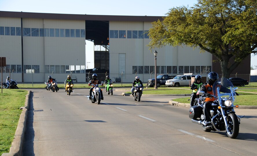 Motorcycle enthusiasts cruise by Hoban Hall during the Thunder on the Bayou motorcycle ride on Barksdale Air Force Base, La., April 5, 2013. The motorcycle ride was more than 100 miles long and took the riders more than two hours to complete. (U.S. Air Force photo/Airman 1st Class Benjamin Gonsier)