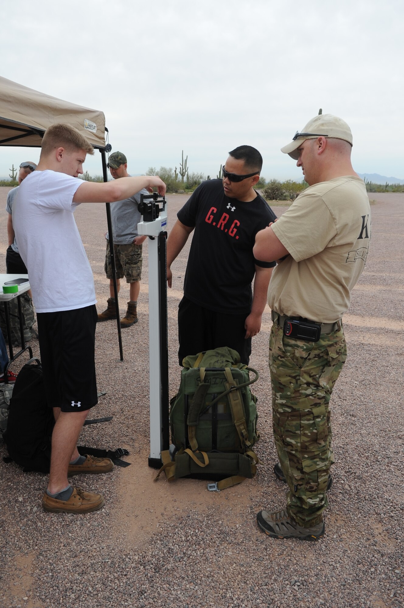 Airman 1st Class Daniel Kilby, 56th Operations Support Squadron air traffic controller, weighs the ruck sack of a March of the Fallen event participant March 30 at the White Tank Mountains Regional Park in Waddell. There were 124 participants who marched and 45 volunteers. The march is 4.75-miles long. (U.S. Air Force photo/Airman 1st Class Pedro Mota)