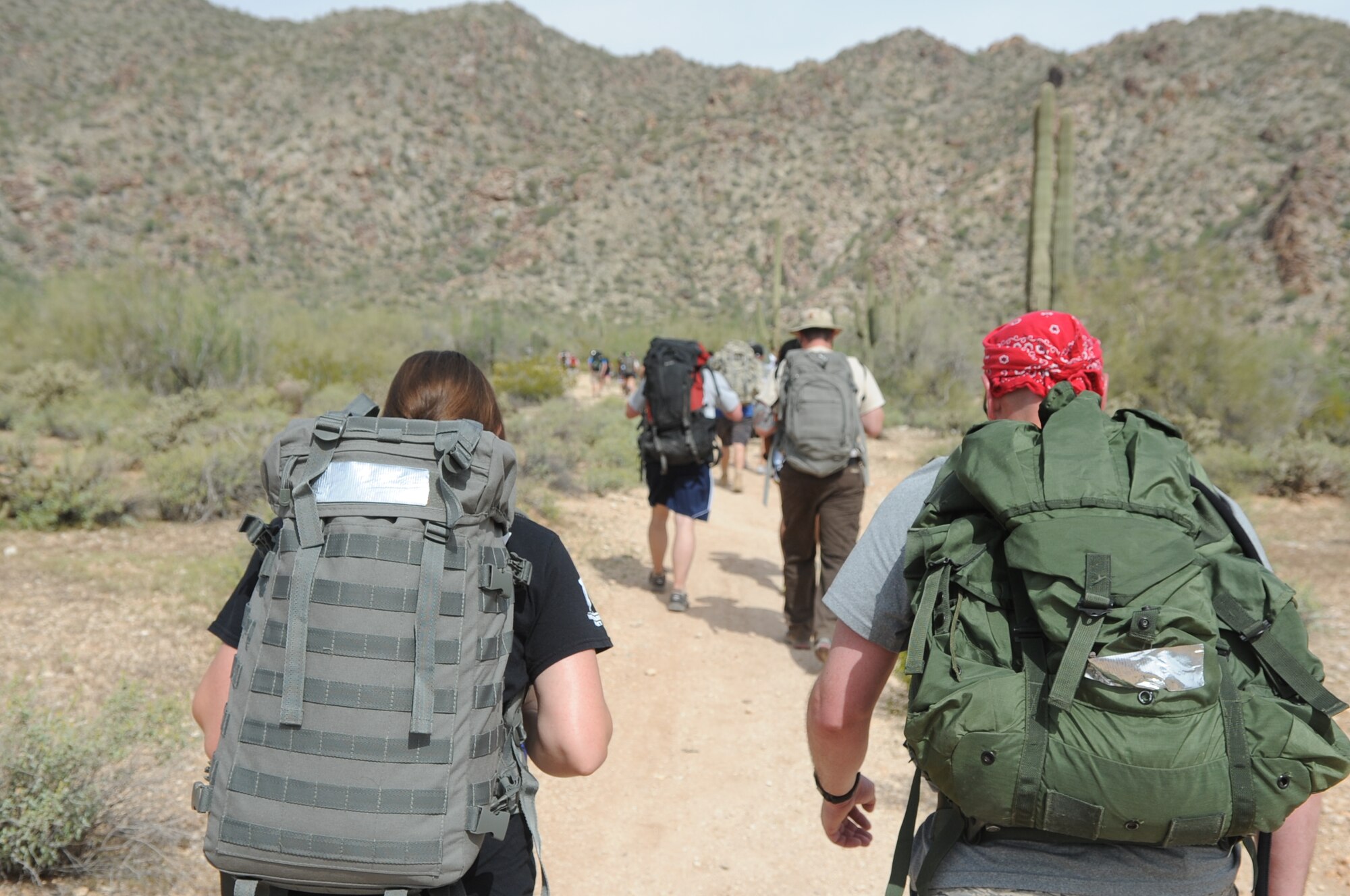 March of the Fallen participants hike up the White Tank Mountains March 30 located in Waddell, Ariz. Their weighted backpacks represented the gear that deployed members carry everyday and to honor fallen warriors. The three weight classes consisted of 45 pounds, 60 pounds and 75 pounds.  All the profits were donated to the Wounded Warrior Project. (U.S. Air Force photo/Airman 1st Class Pedro Mota)
