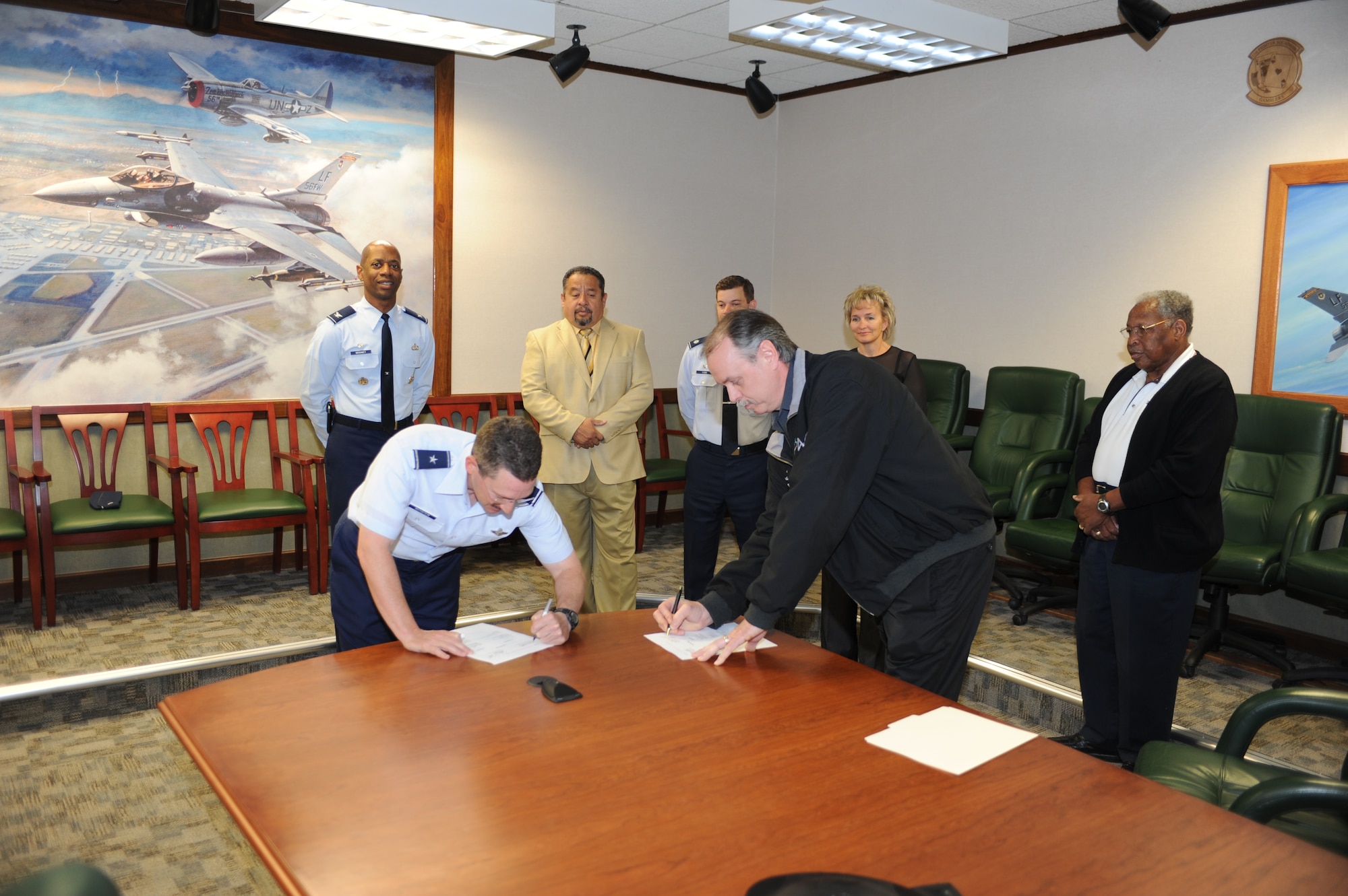 Brig. Gen. Mike Rothstein, 56th Fighter Wing commander, and Harley Hembd, American Federation of Government Employees 1547 Local president, sign the nonappropriated funds contract. This is the first contract of its kind signed between the 56th FW and AFGE 1547 Local regarding nonappropriated fund employees. (U.S. Air Force photo/Staff Sgt. C.J. Hatch)