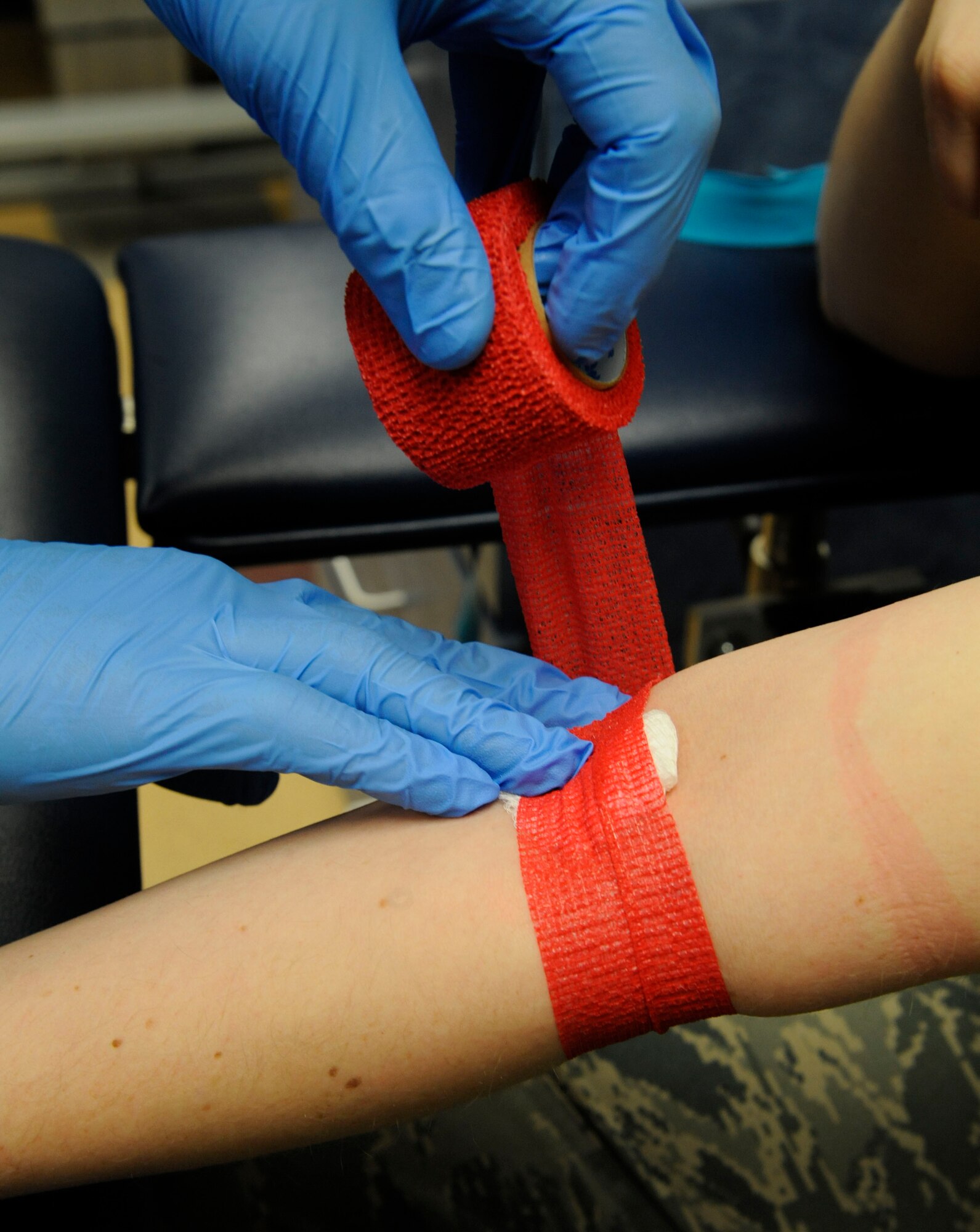 Senior Airman David Eley, 2nd Medical Support Squadron Medical Laboratory lab technician, bandages the arm of a patient after drawing blood on Barksdale Air Force Base, La., April 5, 2013. Lab technicians are responsible for throat cultures, drawing blood, and testing urine samples in order to determine the health and wellness of a patient. (U.S. Air Force photo/Airman 1st Class Andrew Moua)