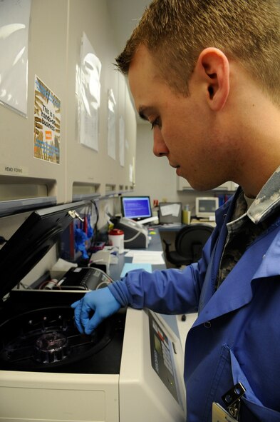Senior Airman David Eley, 2nd Medical Support Squadron Medical Laboratory lab technician, places a blood sample in a stainer on Barksdale Air Force Base, La., April 5, 2013. The stainer will stain the cells within the sample to help the laboratory better differentiate between red blood cells, white blood cells, blood plasma and platelets. (U.S. Air Force photo/Airman 1st Class Andrew Moua)