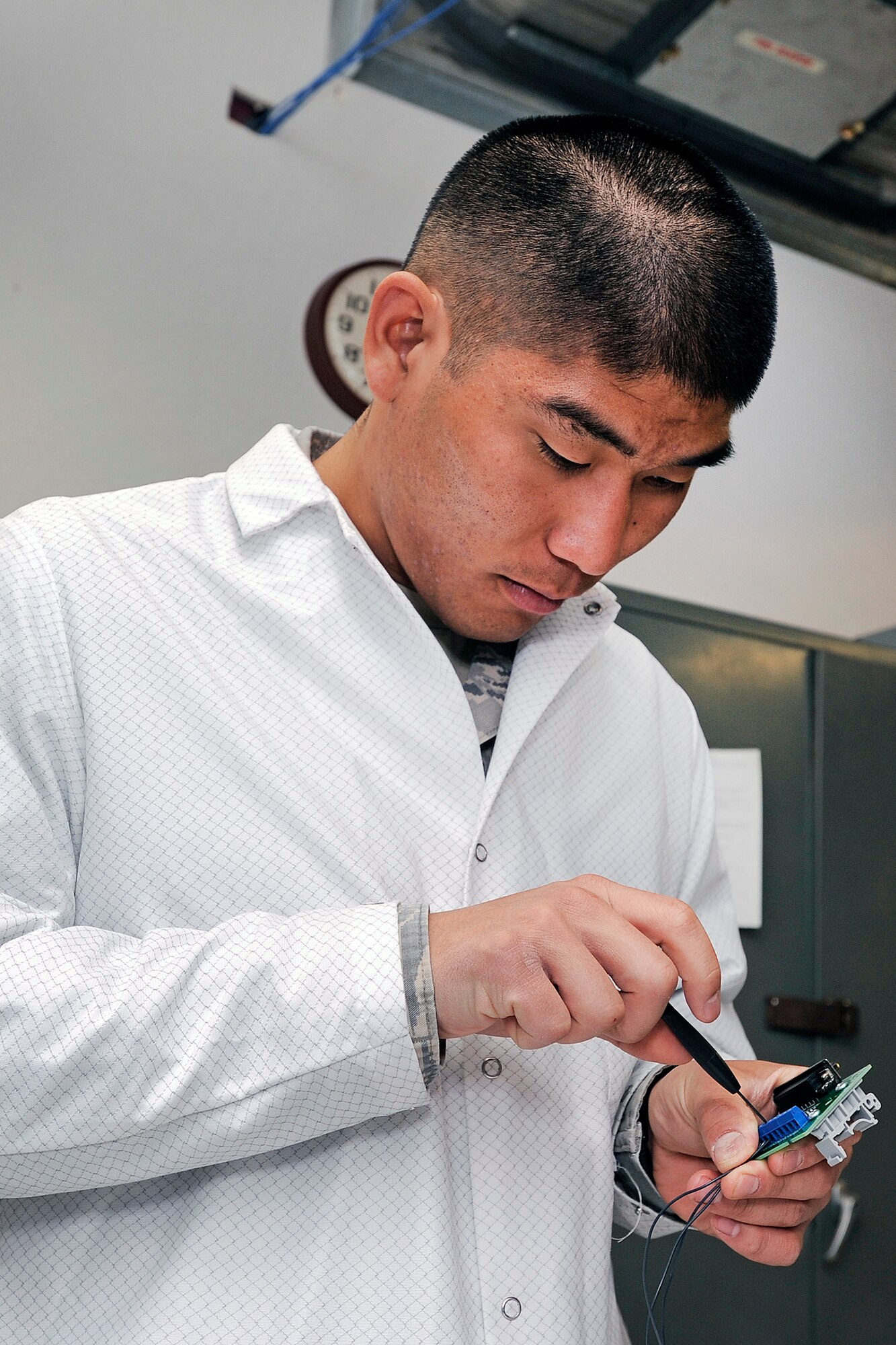 Cadet 1st Class Kevin Ueunten works on a component for Falcon SAT-6 Monday, April 1st. (U.S. Air Force Photo/Sarah Chambers)