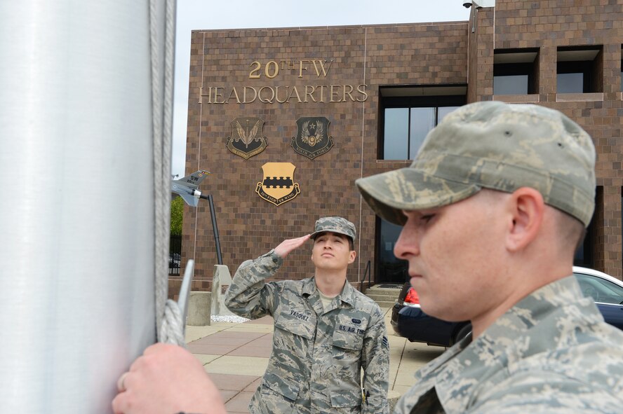 Senior Airman Romaldo Vasquez (left), 20th Fighter Wing knowledge operations manager, salutes the flag as Staff Sgt. William Yttre, 20th FW NCO in charge of the commanders action group lowers it to half-mast, Shaw Air Force Base, S.C., April 5, 2013. Capt. James Steel, 77th Fighter Squadron chief of mobility, was killed in the line of duty April 3, after his aircraft crashed in Afghanistan returning to base from a close air support mission. (U.S. Air Force photo by Airman 1st Class Daniel Blackwell)