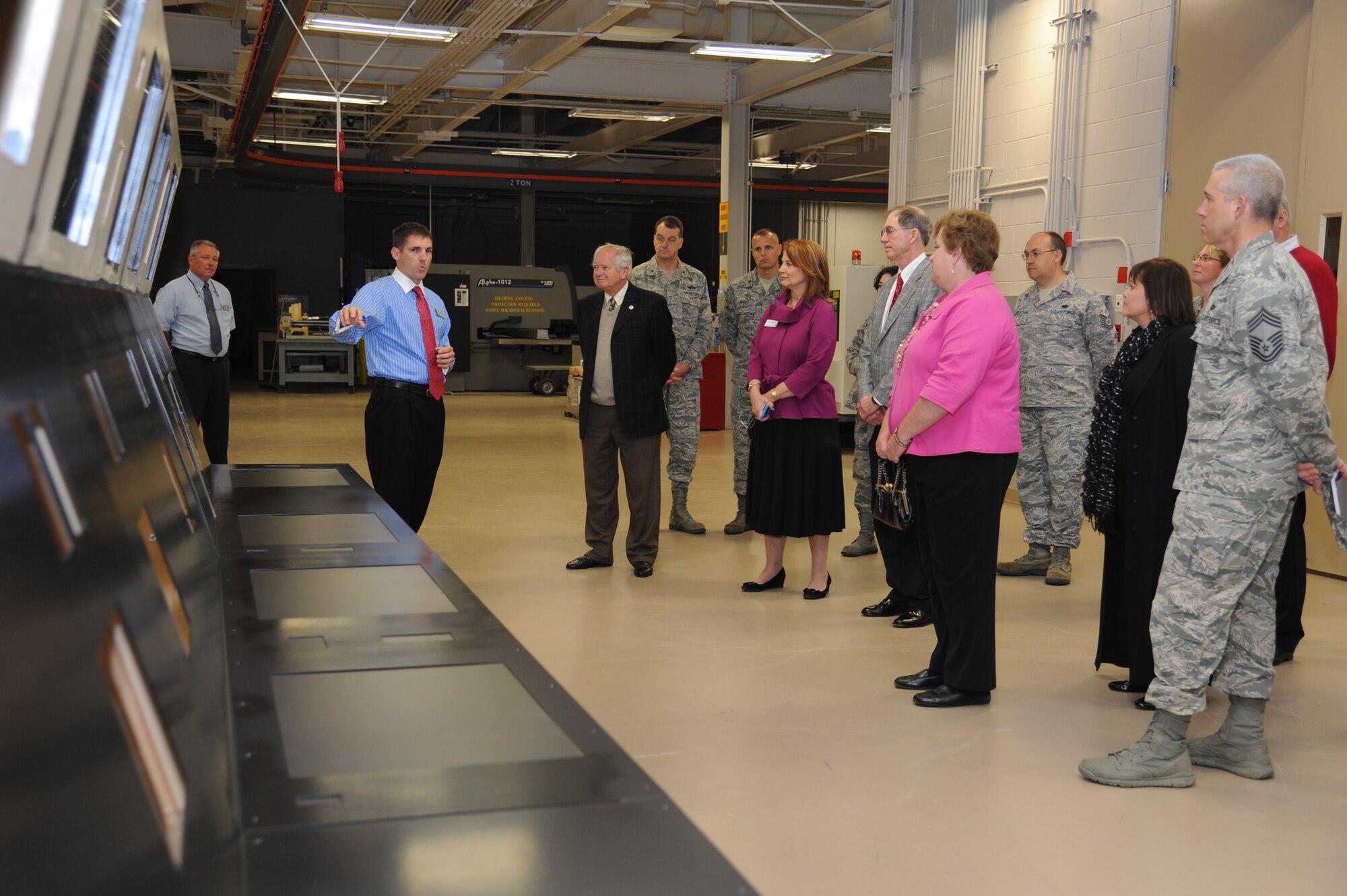 Tomme Lassabe, 81st Training Support Squadron, shows training equipment made at the trainer development center during an honorary commanders tour April 5, 2013, at Keesler Air Force Base, Miss.  The Keesler Honorary Commanders Program informs selected non-federal elected officials, chamber of commerce members and other civic leaders about the missions of Keesler and the Air Force and fosters positive relationships with the base’s community partners.  This visit focused on the mission of the 81st Training Group.  (U.S. Air Force photo by Kemberly Groue)