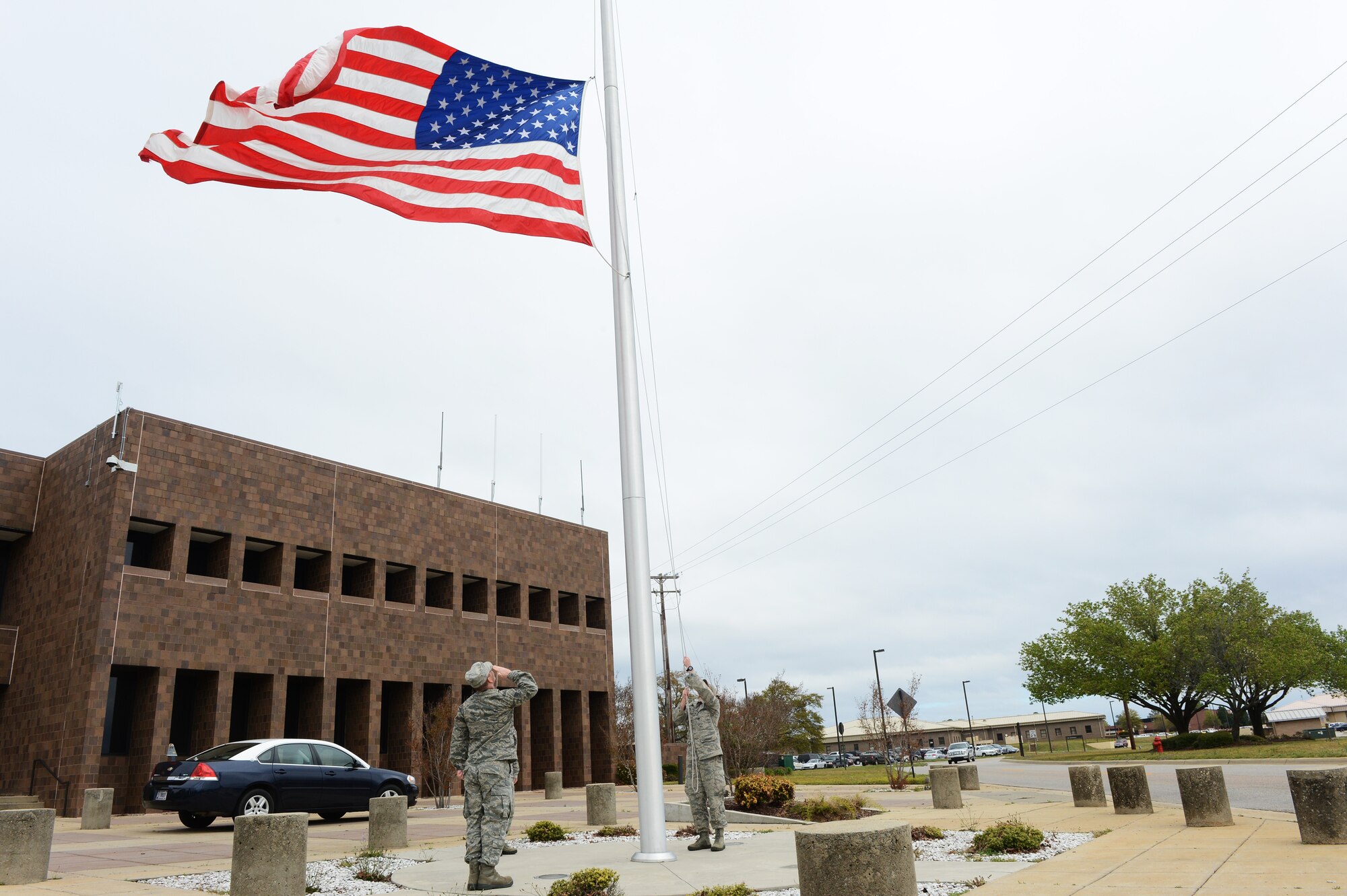 20th Fighter Wing Airmen lower the flag to half-mast at Shaw Air Force Base, S.C., April 5, 2013. Capt. James Steel, 77th Fighter Squadron chief of mobility, was killed in the line of duty April 3, after his aircraft crashed in Afghanistan returning to base from a close air support mission. (U.S. Air Force photo by Airman 1st Class Daniel Blackwell)