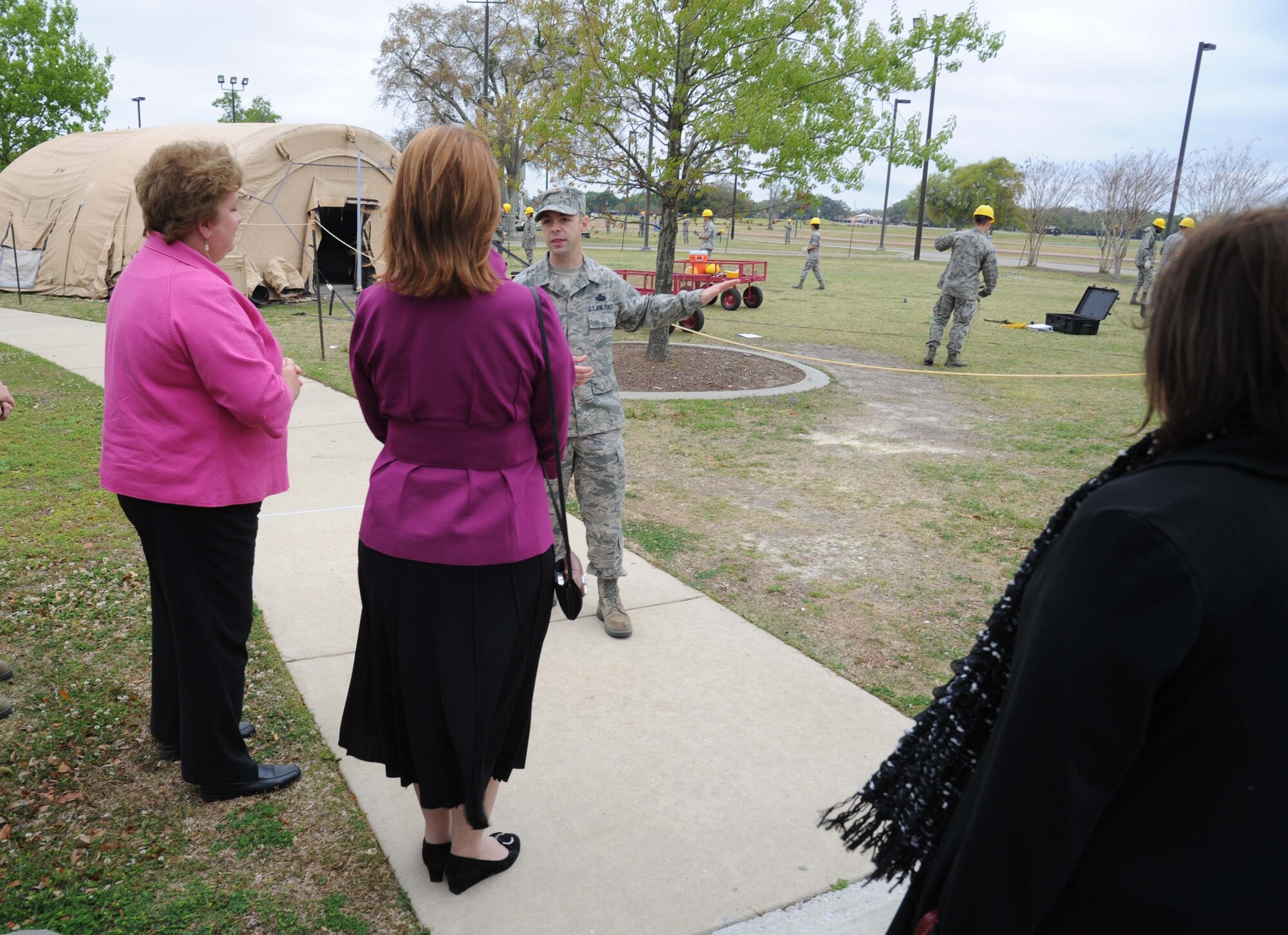 Adele Lyons, Habitat for Humanity for the Mississippi Gulf Coast director of development, and Ocean Springs Mayor Connie Moran receive a briefing from Master Sgt. Anthony Barattini, 338th Training Squadron, on the air expeditionary force area in the Triangle training area during an honorary commanders tour April 5, 2013, at Keesler Air Force Base, Miss.  The Keesler Honorary Commanders Program informs selected non-federal elected officials, chamber of commerce members and other civic leaders about the missions of Keesler and the Air Force and fosters positive relationships with the base’s community partners.  This visit focused on the mission of the 81st Training Group.  (U.S. Air Force photo by Kemberly Groue)
