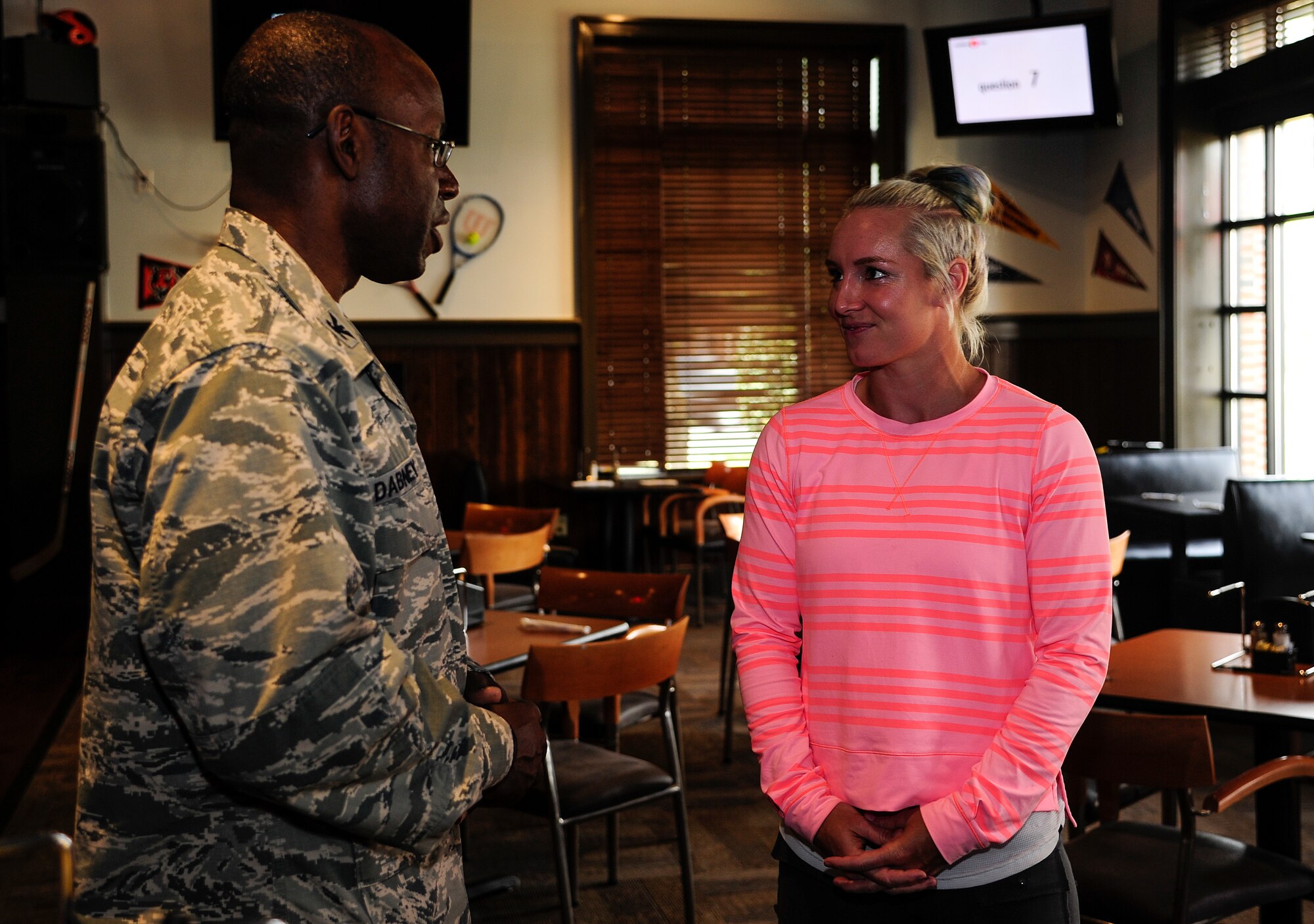 Col. Dennis Dabney, 437th Maintenance Group commander, talks with professional tennis player Bethanie Lynn Mattek-Sands April 3, 2013, at Rookies Sports Grill at Joint Base Charleston – Air Base, S.C. Mattek-Sands was in Charleston competing in the Family Circle Cup tennis tournament and visited the Air Base to sign autographs for Team Charleston members and to tour a C-17 Globemaster III. (U.S. Air Force photo by Staff Sgt. Rasheen Douglas)