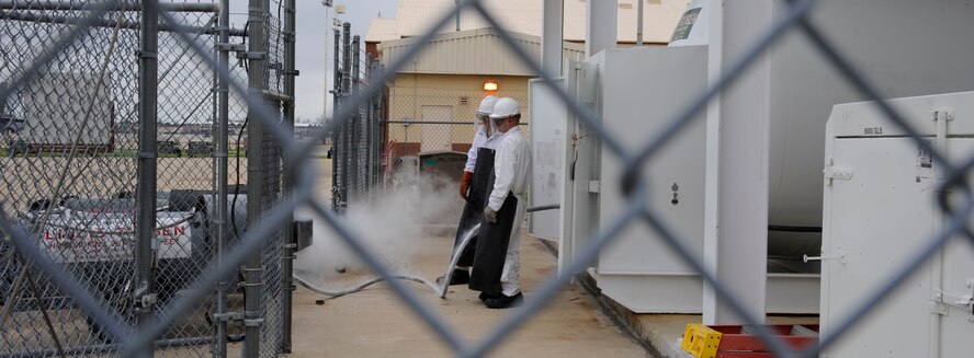 Staff Sgt. Mitchell Newman and Senior Airman Daniel Bohn,  2nd Logistics Readiness Squadron Fuels Facilities, fill lox carts with liquid oxygen on Barksdale Air Force Base, La., April 4, 2013. The fuels facilities section is in charge of the receipt, storage and distribution on fuel for Barksdale's fleet of B-52H Stratofortress bombers. (U.S. Air Force photo/Airman 1st Class Andrew Moua)