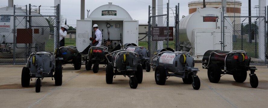 Staff Sgt. Mitchell Newman and Senior Airman Daniel Bohn, 2nd Logistics Readiness Squadron Fuels Facilities, fill lox carts with liquid oxygen on Barksdale Air Force Base, La., April 4, 2013. The liquid oxygen carts are used by crew chiefs to supply a B-52H Stratofortress crew with a source of breathable air during flight. (U.S. Air Force photo/Airman 1st Class Andrew Moua)