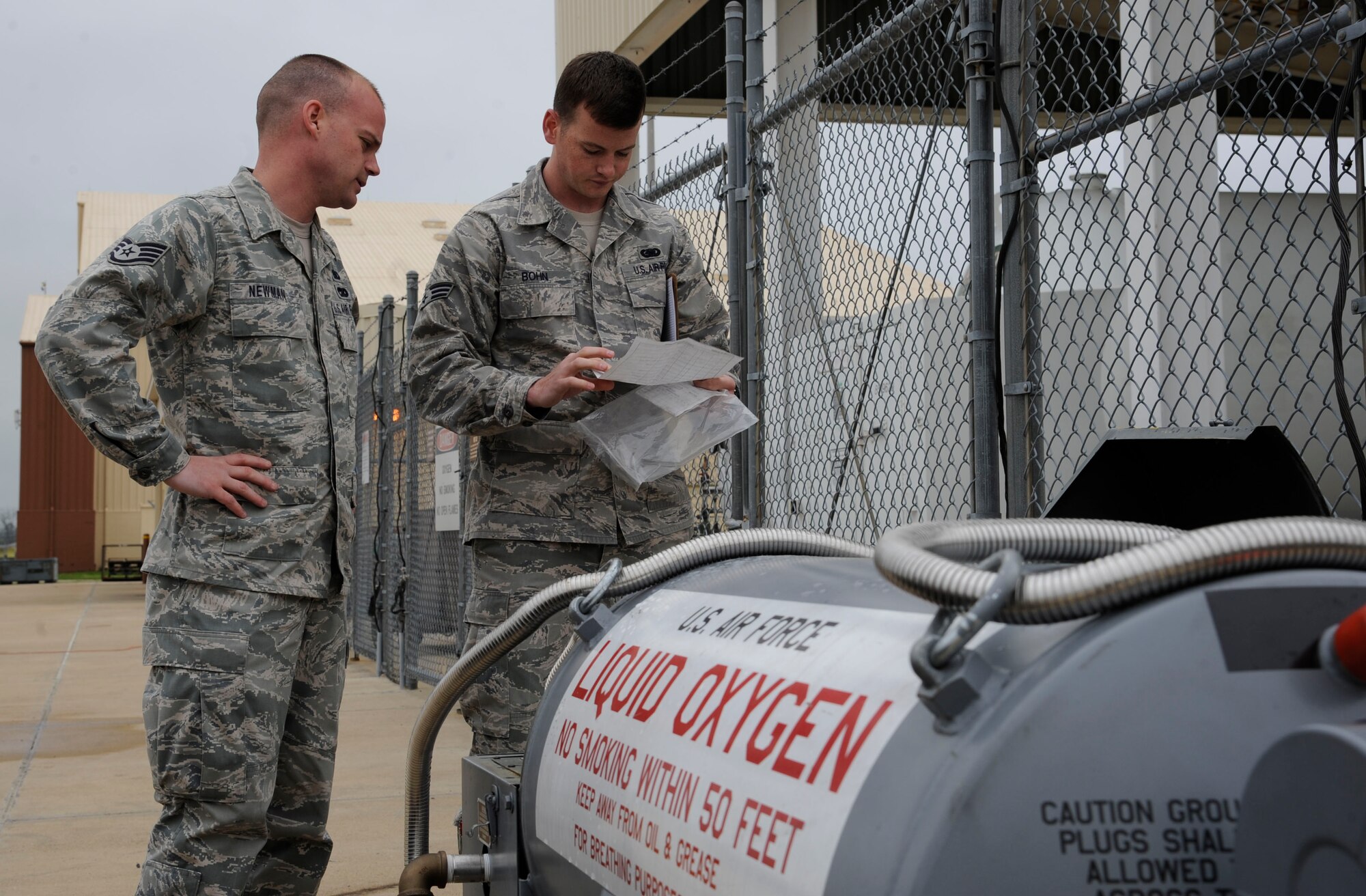 Staff Sgt. Mitchell Newman and Senior Airman Daniel Bohn,  2nd Logistics Readiness Squadron Fuels Facilities, look over checklists before refilling liquid oxygen carts on Barksdale Air Force Base, La., April 4, 2013. The liquid oxygen carts are used by crew chiefs to supply a B-52H Stratofortress crew with a source of breathable air during flight. (U.S. Air Force photo/Airman 1st Class Andrew Moua)