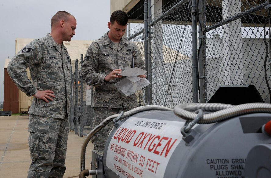 Staff Sgt. Mitchell Newman and Senior Airman Daniel Bohn,  2nd Logistics Readiness Squadron Fuels Facilities, look over checklists before refilling liquid oxygen carts on Barksdale Air Force Base, La., April 4, 2013. The liquid oxygen carts are used by crew chiefs to supply a B-52H Stratofortress crew with a source of breathable air during flight. (U.S. Air Force photo/Airman 1st Class Andrew Moua)