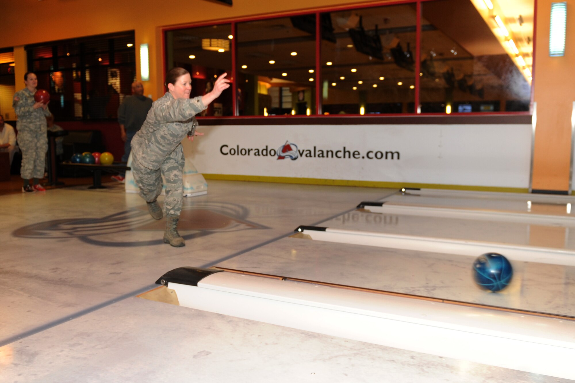 Col. Tracey Hayes, 460th Space Wing vice commander, throws a bowling ball April 2, 2013, at Celebrity Lanes bowling center, Centennial, Colo. “Striking Against Sexual Assault” was the theme of the bowling event, which promoted awareness for sexual assault. (U.S. Air Force photo by Senior Airman Marcy Glass/Released