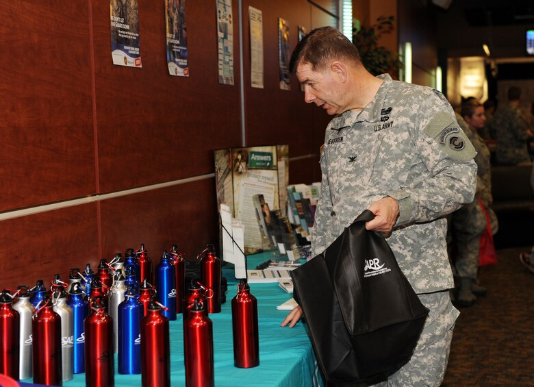 Col. Andy Meveroen, Joint Forces Headquarters command chaplain, looks at Sexual Assault Awareness Month products April 2, 2013, at Celebrity Lanes bowling center, Centennial, Colo. The “Striking Against Sexual Assault” bowling event raised awareness for sexual assault. (U.S. Air Force photo by Senior Airman Marcy Glass/Released)