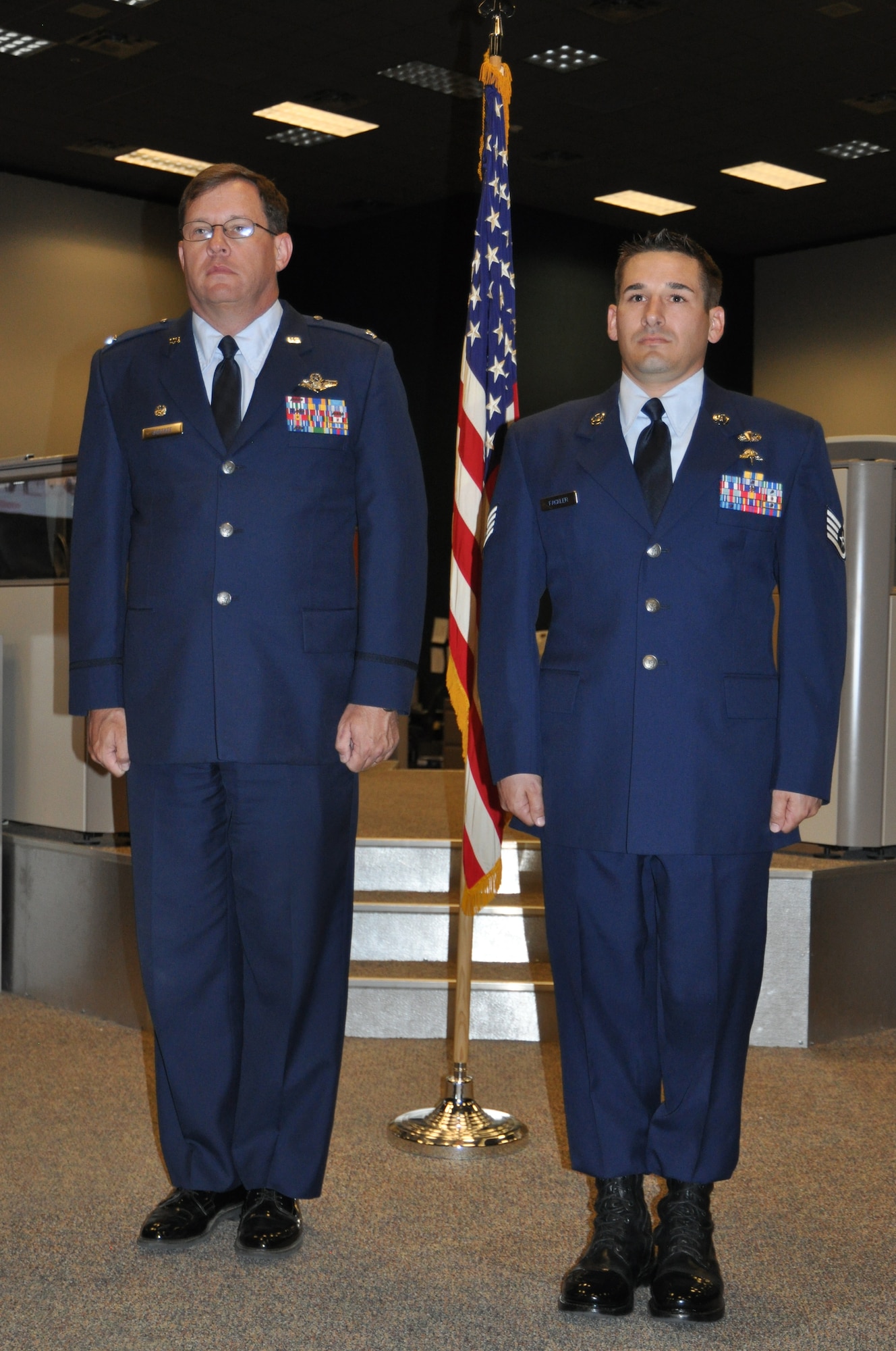 Col. James Bortree, 612th Air and Space Operations Center commander, stands at attention with Staff Sgt. Staff Sgt. Darren C. Fackler, 612th AOC Survival, Evasion, Resistance and Escape specialist, during Fackler’s Purple Heart recognition ceremony at Davis-Monthan AFB, Ariz., April 4. (USAF photo by Master Sgt. Kelly Ogden/Released). 