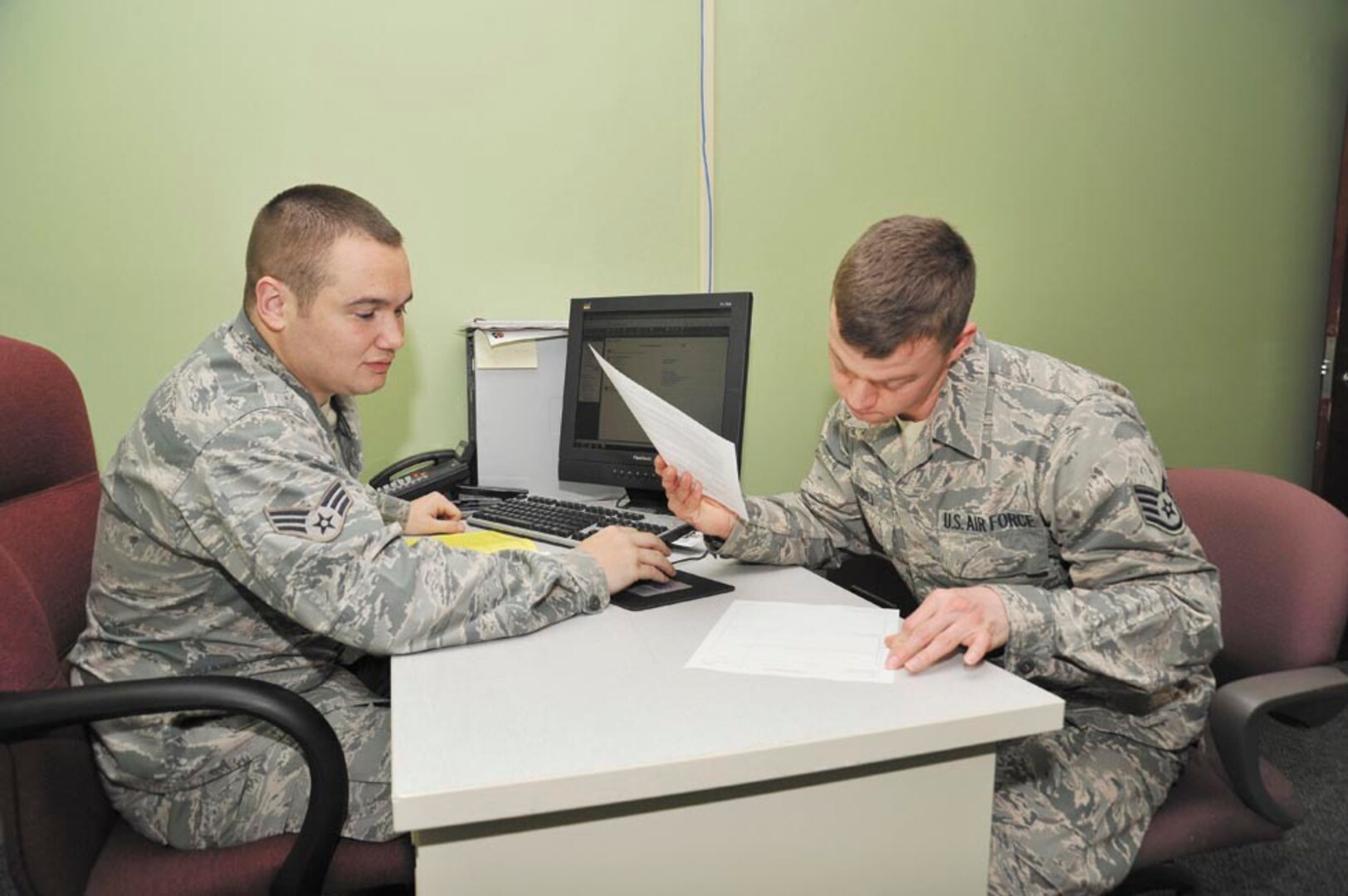 Staff Sgt. Seth Kubli (right) looks over his 2012 tax return prepared by Senior Airman Phillip Rodriguez, a volunteer at the JBSA-Lackland Tax Center. The center helped Kubli get state income tax refunds from 2010 and 2011 after discovering a mistake in
his previous filings. (Photo by Alan Boedeker)