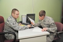 Staff Sgt. Seth Kubli (right) looks over his 2012 tax return prepared by Senior Airman Phillip Rodriguez, a volunteer at the JBSA-Lackland Tax Center. The center helped Kubli get state income tax refunds from 2010 and 2011 after discovering a mistake in
his previous filings. (Photo by Alan Boedeker)