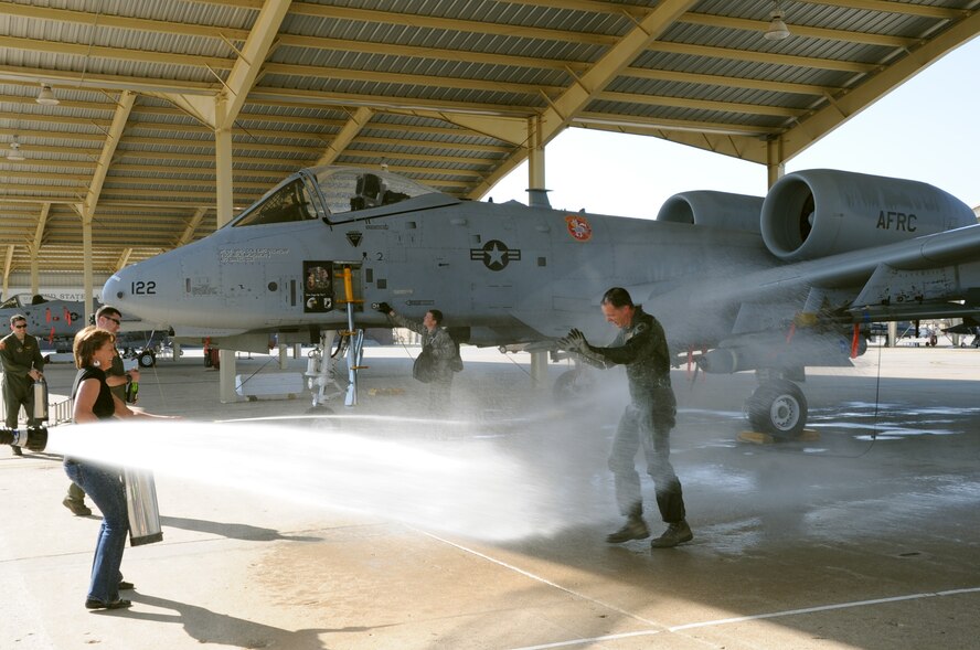 Brig. Gen. Eric Overturf, 442nd Fighter Wing commander, is sprayed with water from a flightline hose by his family after flying his “fini” flight with the 442nd FW, April 4, 2013. The “fini” flight is a tradition commemorating the final flight of a pilot. (U.S. Air force photo/Staff Sgt. Lauren Padden)