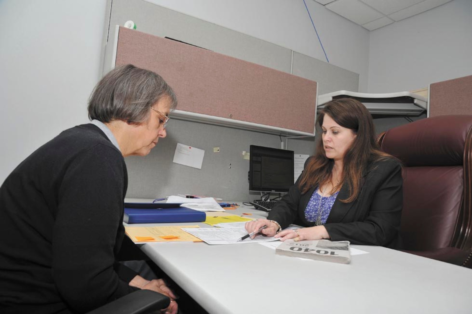 Linda Vaillancourt (right), a JBSA-Lackland Tax Center volunteer preparer, reviews Amy Ramey’s tax return before filing it with the In-Volunteers ternal Revenue Service. (Photo by Alan Boedeker)