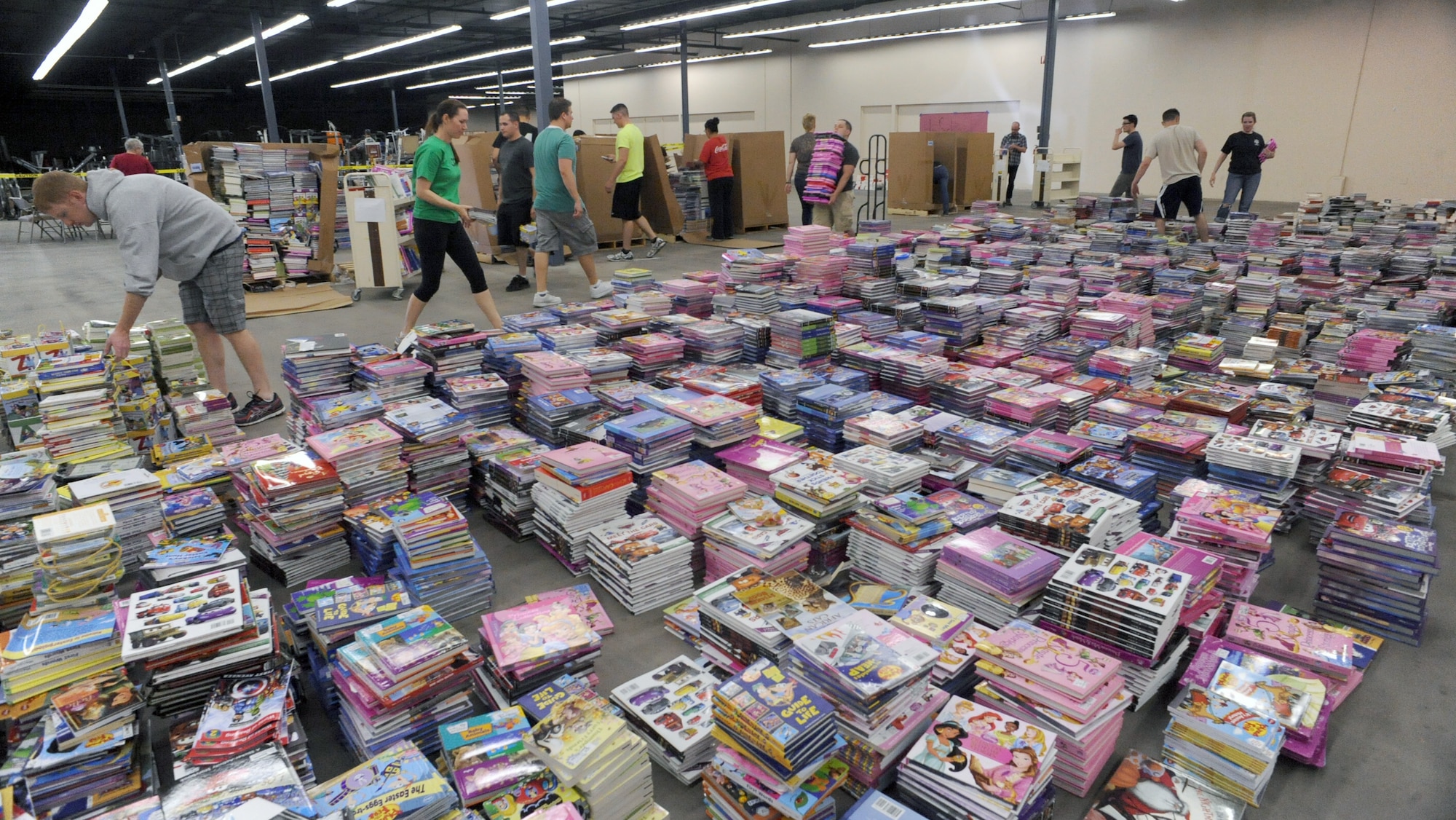 U.S. Air Force Airmen and Tucson citizens sort books at the Bookman’s warehouse for First Book Tucson in Tucson, Ariz., April 2, 2013. Approximately 40,000 books were unpacked, sorted and stacked for children from pre- kindergarten to high school. (U.S. Air Force photo by Airman 1st Class Christine Griffiths/Released)