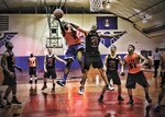 Maurice Jenkins-Day, 802nd Force Support Squadron, goes for a layup while Larry Howard, 543rd Support Squadron, attempts to block the shot. (Photo by Robbin Cresswell)