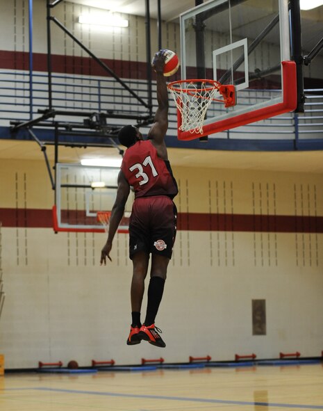 Alexander Wright Jr., Harlem Ambassadors basketball player, dunks the ball during the final seconds of the game against the Ellsworth All Stars at the Bellamy Fitness Center on Ellsworth Air Force Base, S.D., March 26, 2013. The Ellsworth All Stars put up a good fight but came up short with a final score of 48-82. (U.S. Air Force photo by Tech. Sgt. Jerry Fleshman/Released)