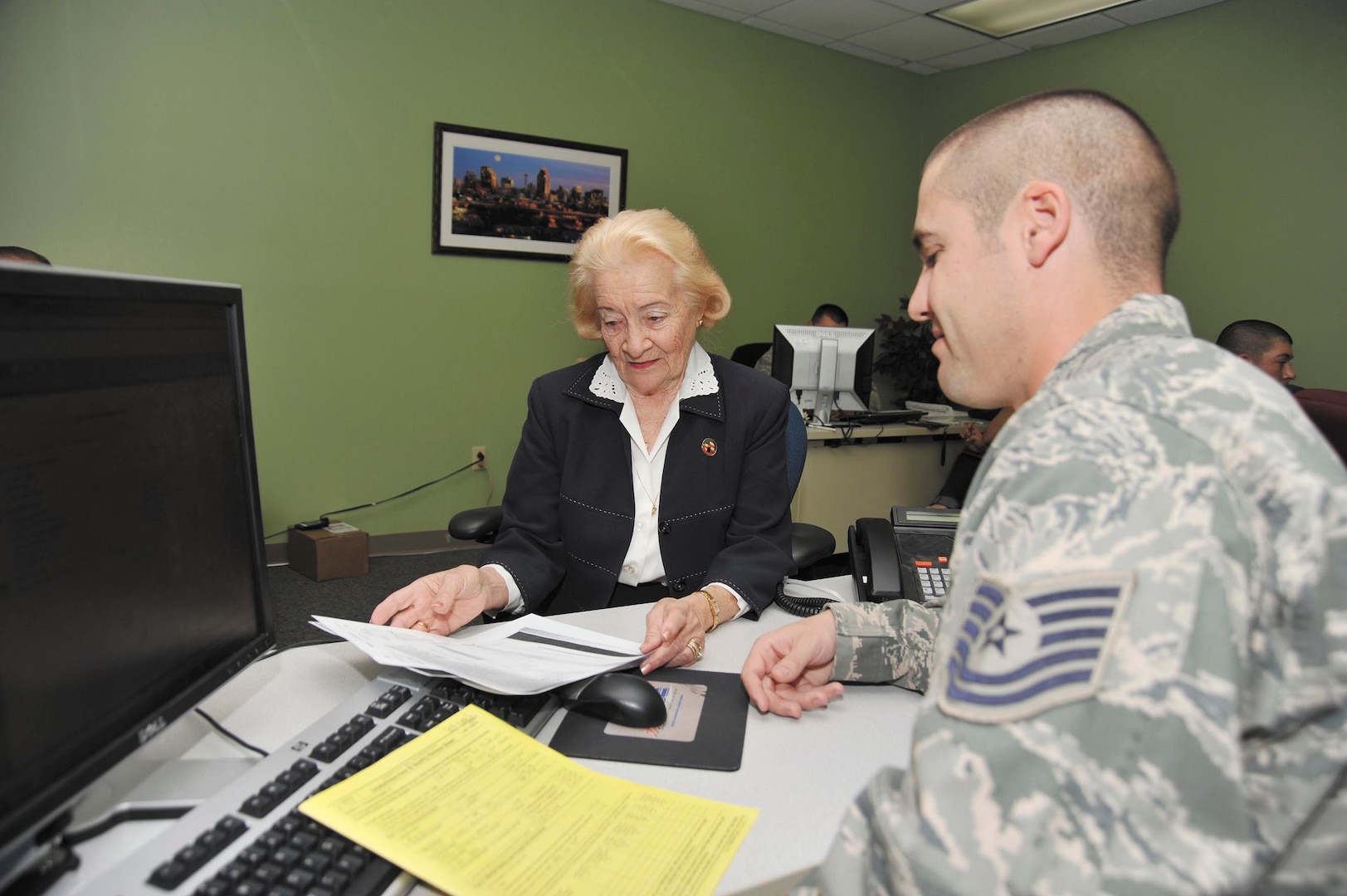 Dr. Tricia Hall goes over her 2012 income tax return with Tech. Sgt. Joseph Duffy,  volunteer preparer at the Joint Base San Antonio-Lackland Tax Center. Hall said using the center for her income tax preparation and filing has been a “wonderful experience,” which she attributed to the volunteers, preparation fee savings and location convenience. (Photo by Alan Boedeker)