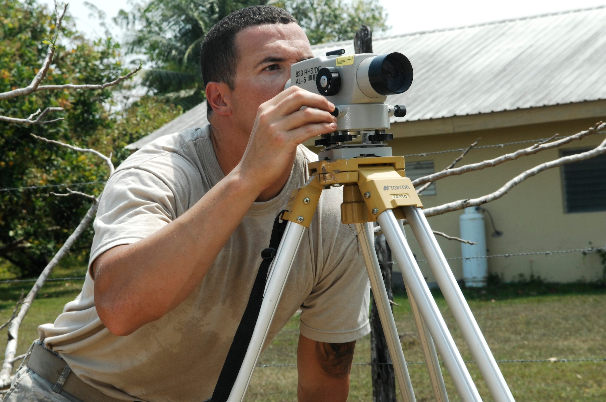 Staff Sgt. Joel Bradley, engineering assistant for the 823rd Red Horse Squadron, sets an auto level to check the final grade elevation at the construction site of the future Crooked Tree Government Primary School March 23, 2013. Civil engineers from both the U.S. and Belize will construct various structures at schools throughout Belize as part of an exercise called New Horizons. (U.S. Air Force photo/Master Sgt. James Law)