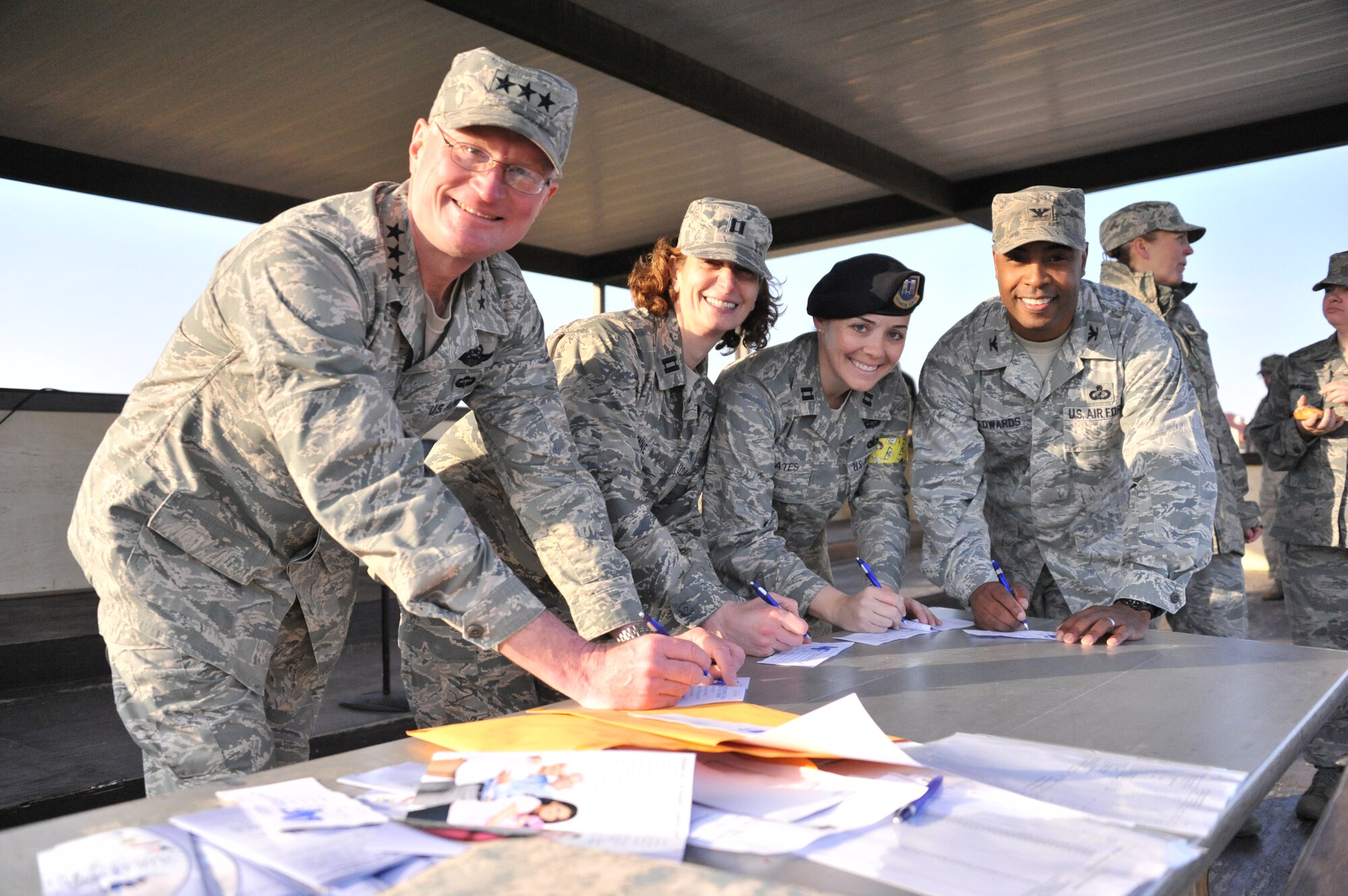 Lieutenant Gen. David Fadok, left, commander and president of the Air University, and Col. Trent Edwards, right, 42nd Air Base Wing commander, complete their 2013 Air Force Assistance Fund donation forms with Captains Neysa Etienne and Cassandra Bates, 2013 AFAF project officers, during the kickoff rally March 29. (U.S. Air Force photo by Staff Sgt. Sandra Percival)
