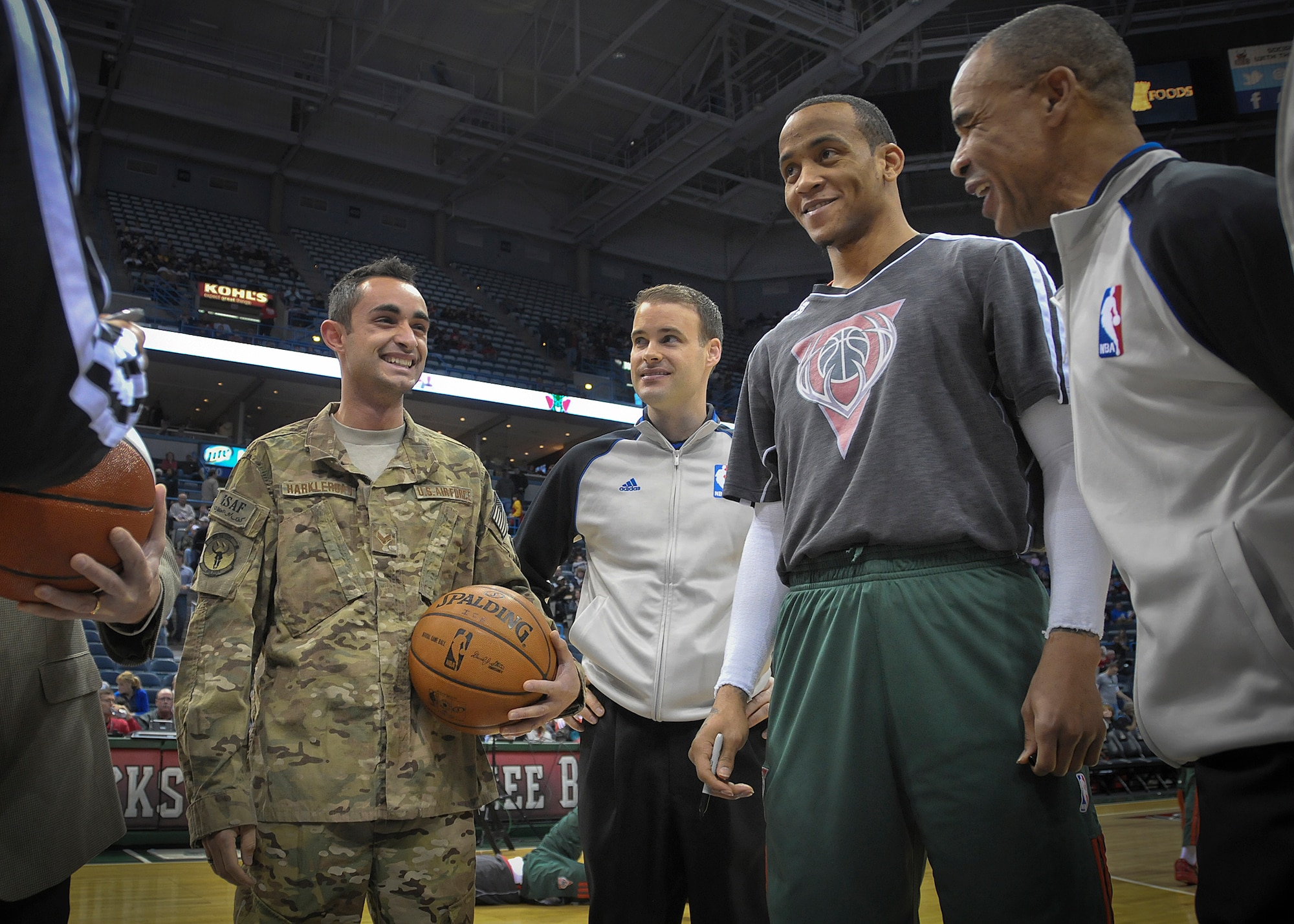 Senior Airman Jefferson Harkleroad is all smiles at center court of the BMO Harris Bradley Center in Milwaukee Wed., April 3, 2013.  
Harkleroad, an Air Force electrician serving in the Civil Engineering Squadron at Milwaukee’s 128th Air Refueling Wing, was honored by the Milwaukee Bucks and Waukesha Metal as part of their “Hardwood Homecoming” program. (Air National Guard Photo by 1st Lt. Nathan Wallin / Released)