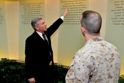 Kevin Smith, head of Air Force Mortuary Affairs Operations' Marine Corps Liaison Team, describes to U.S. Marine Corps Cpl. Landon Beaty, a service liaison, the 1983 Beirut, Lebanon, incident listed on the memorial wall inside the Charles C. Carson Center for Mortuary Affairs, Dover Air Force Base, Del. The wall commemorates 65 mass fatality incidents handled by the Port Mortuary over the past 45 years. Smith was on board the U.S.S. New Jersey, which supported U.S. operations in Lebanon, including the Beirut barracks bombing that killed more than 200 Marines and a Sailor from Smith's battleship.  (U.S. Air Force photo/David Tucker)
