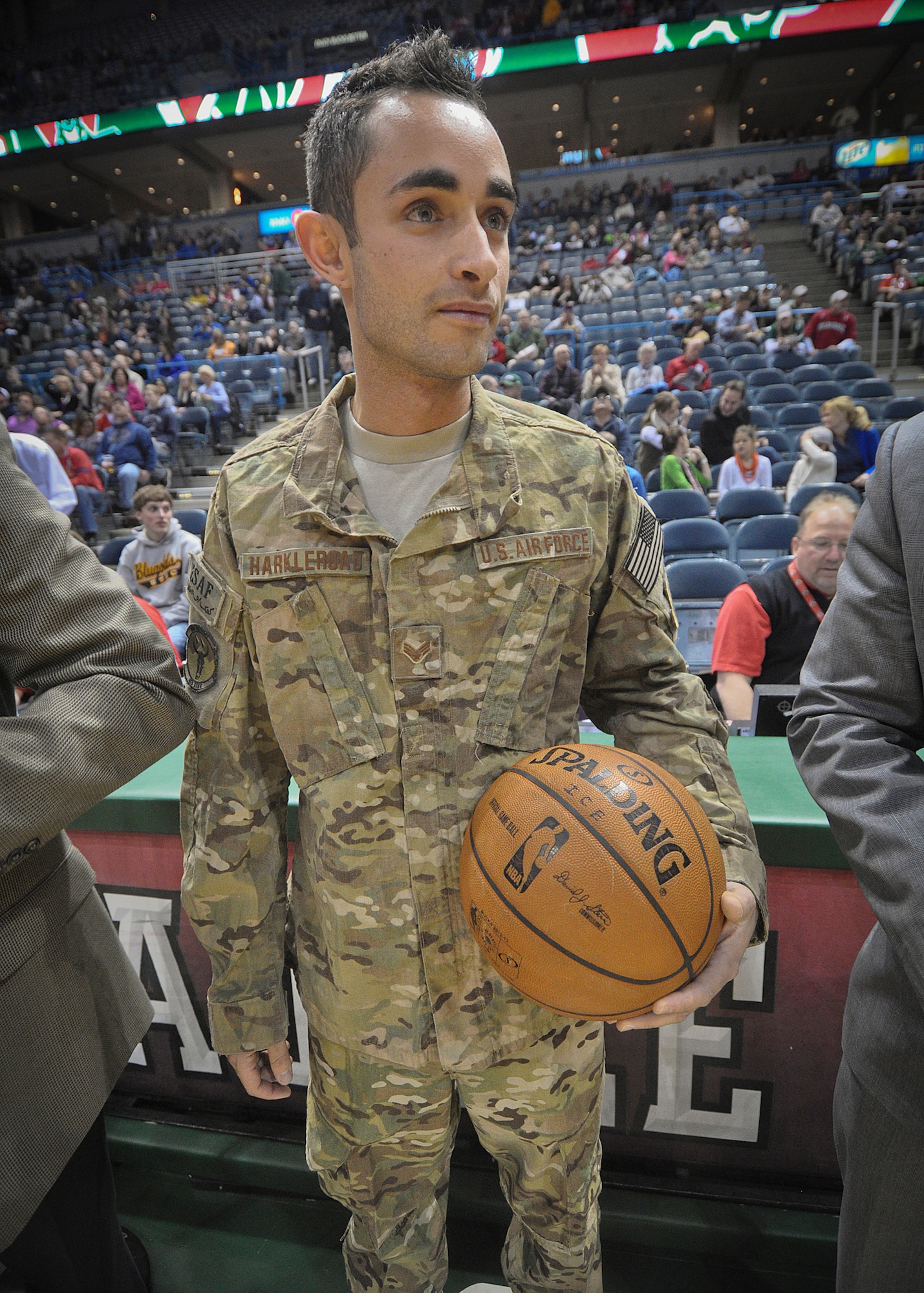 Senior Airman Jefferson Harkleroad holds the official game ball for the Milwaukee Bucks’ game versus the Minnesota Timberwolves at the BMO Harris Bradley Center in Milwaukee Wed., April 3, 2013.
Harkleroad, a member of Milwaukee’s 128th Air Refueling Wing who recently returned from a deployment in Afghanistan, presented the game ball to the Bucks team captain, NAME, at center court as part of the Bucks’ “Hardwood Homecoming” program.  (Air National Guard Photo by 1st Lt. Nathan Wallin / Released)