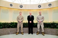 The Marine Corps Liaison Team stands in front of the memorial wall of the Charles C. Carson Center for Mortuary Affairs, Dover Air Force Base, Del., April 2, 2013. From left to right are Marine Corps Staff Sgt. John Clements, Kevin Smith and Marine Corps Cpl. Landon Beaty. The specialized team coordinates the details associated with the return of fallen Marines. (U.S. Air Force photo/David Tucker)