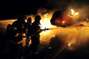 Air Force firefighters assigned to the 106th Rescue Wing train with civilian firefighters to remove simulated victims from a burning aircraft April 2, 2013, at F.S. Gabreski Air National Guard Base in Westhampton, New York. The Airmen are assigned to the 106th Civil Engineering Squadron. Kellogg University provided the mock aircraft, which burned propane at an estimated 1,200 degrees. (U.S. Air Force photo/Senior Airman Christopher Muncy)
