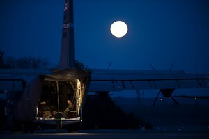 Beneath the light of a full moon, Airmen from the 19th Airlift Wing prepare a C-130J Hercules for a flight March 27, 2013, at Little Rock Air Force Base, Ark. The 19th Wing's responsibilities range from supplying humanitarian airlift relief to victims of disasters, to airdropping supplies and troops into the heart of contingency operations in hostile areas. (U.S. Air Force photo/Staff Sgt. Russ Scalf)