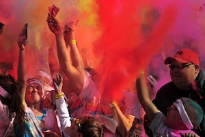 Colored powder is thrown into the air after participants complete The Color Run™ 5K March 23, 2013, in Lubbock, Texas. Airmen from Cannon Air Force Base, N.M, and members of the surrounding communities participated in the race. The Color Run™, also known as the Happiest 5k on the planet, is a unique paint race that celebrates healthiness, happiness, individuality and giving back to the community. (U.S. Air Force photo/2nd Lt. Angelica Powell)