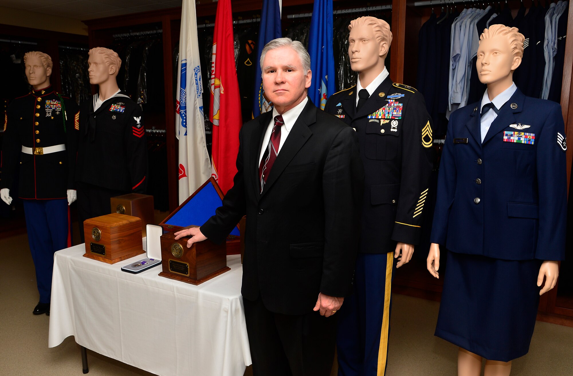 Kevin Smith, Air Force Mortuary Affairs Operations, Dover Air Force Base, Del., rests his hand on one of the types of urns the family of a fallen Marine can choose April 2, 2013. Smith is the head of the Marine Corps Liaison Team at Dover Air Force Base, Del. (U.S. Air Force photo/David Tucker)
