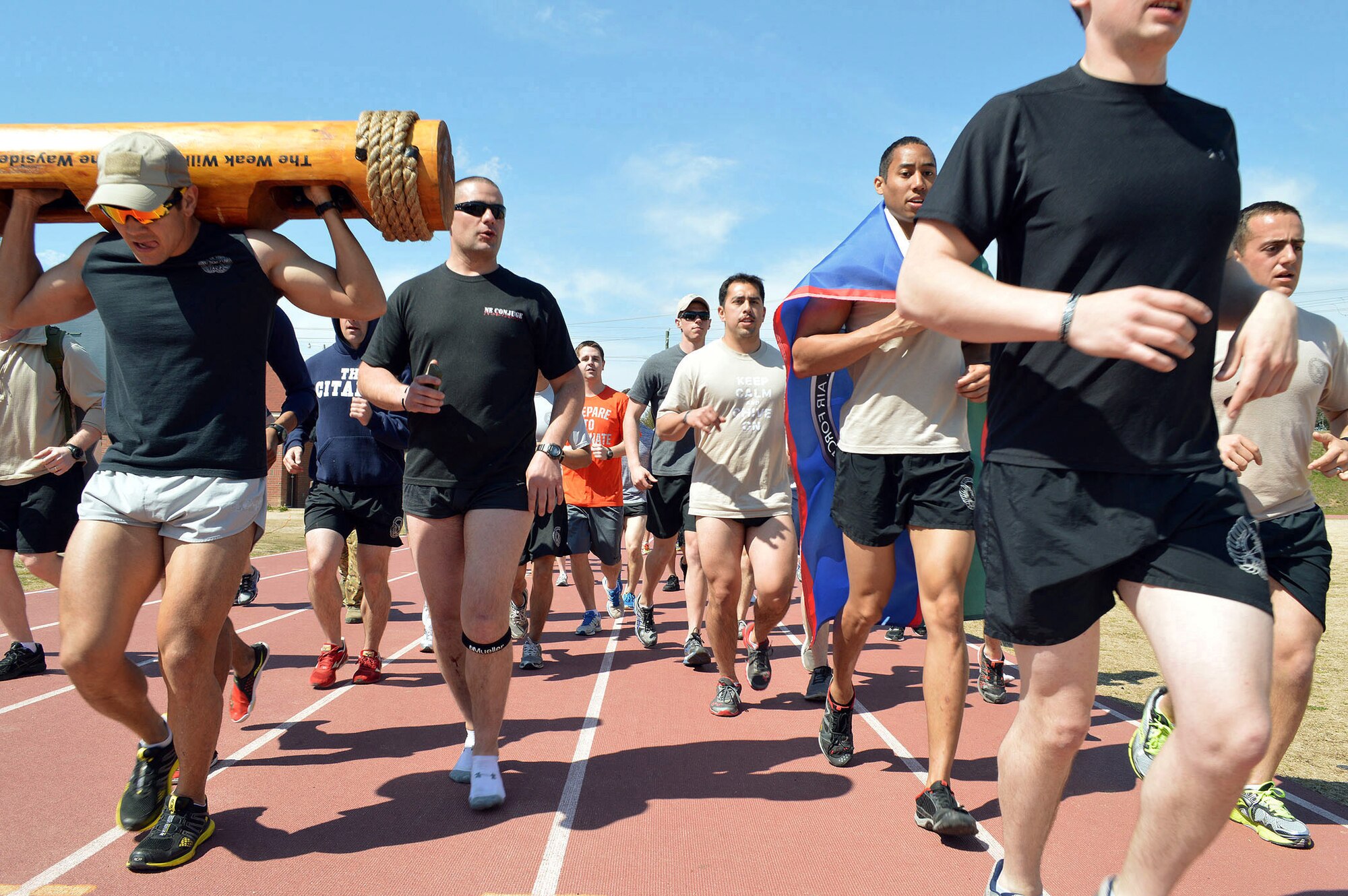 Tactical Air Control Party Airmen assigned to Pope Army Airfield, Fort Bragg, N.C., units run the final lap together at the Hedrick Stadium track during the second annual worldwide TACP 24-hour Run Challenge fundraising event.  The event is held to honor and raise funds for fallen TACP brothers in arms and their families.  (U.S. Air Force photo by Marvin Krause/Released)