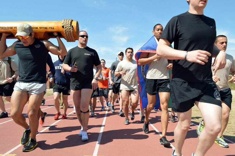 Tactical Air Control Party Airmen assigned to Pope Army Airfield, Fort Bragg, N.C., units run the final lap together at the Hedrick Stadium track during the second annual worldwide TACP 24-hour Run Challenge fundraising event.  The event is held to honor and raise funds for fallen TACP brothers in arms and their families.  (U.S. Air Force photo by Marvin Krause/Released)